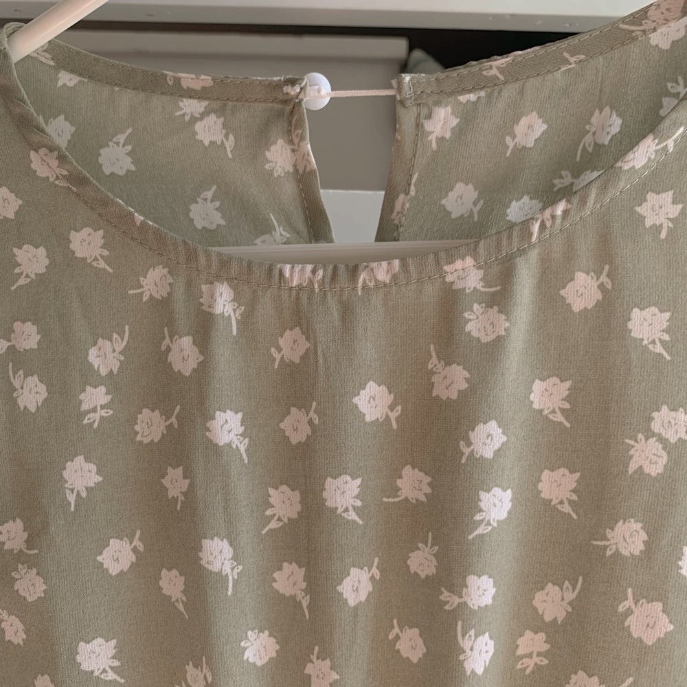 I’m selling a light green dress with white flowers.
